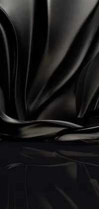 This phone live wallpaper depicts a stunning black cloth on a table with a glossy and drippy finish in 4K HD resolution