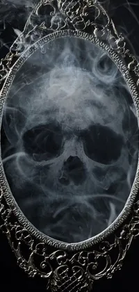 If you're looking for a spine-chilling live wallpaper for your phone, check out this skull and mirror masterpiece! The wallpaper depicts a skull in profile, with smoke emanating from its empty sockets and mandible