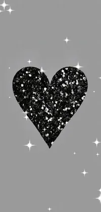 This phone live wallpaper showcases a black glitter heart on a grey background