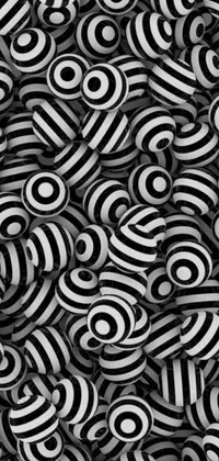 This phone live wallpaper showcases an eye-catching black and white swirl theme against a black background