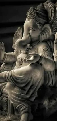 Looking for a unique and eye-catching live wallpaper for your phone? Check out this stunning black and white photo of a elephant statue! This intricately detailed ivory carving has been captured in beautiful detail, with the elephant sitting in a pose of reverence and wisdom