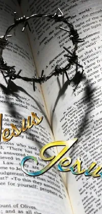 This live wallpaper features a digital rendering of a crown of thorns on top of an open book, with a heart symbol for Jesus Christ and a journalistic text line
