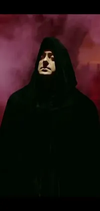 This phone live wallpaper depicts a black-robed figure standing against a vibrant red sky, with a hood covering much of his face