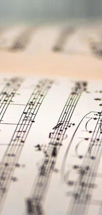 Looking for a phone wallpaper that will strike a chord with your love for music? Look no further than our close-up sheet music live wallpaper! This traditional and elegant wallpaper features a thumbnail format that fits perfectly on your phone screen