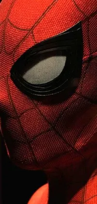 Looking to add some superhero excitement to your phone's display? Check out this amazing live wallpaper featuring a close-up shot of someone wearing a Spider-Man mask! This photorealistic image showcases stunning cinematic styling and intense attention to detail in every aspect of the mask