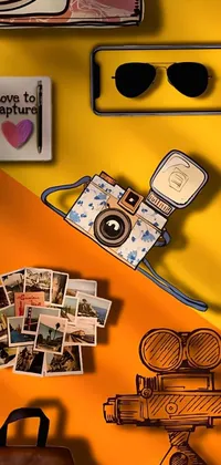This phone live wallpaper features a vintage camera and a graffiti patterned bag on a wooden table