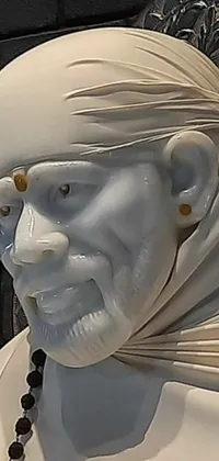 This live phone wallpaper showcases a striking close-up of a marble statue of a man