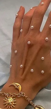 Looking for a striking phone live wallpaper that will take your breath away? Check out this incredible image featuring a close-up of a hand adorned with delicate pearls