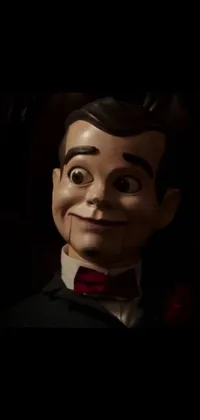Introducing an eerie live wallpaper for your phone, featuring a creepy statue of a man in formal attire