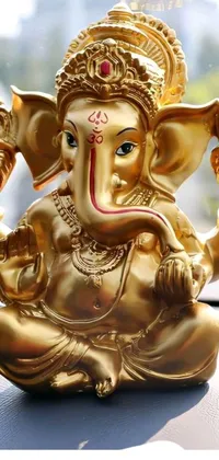 This phone live wallpaper showcases a close up of a stunning golden elephant statue
