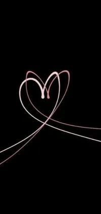 This phone live wallpaper features a striking heart-shaped light painting against a black background