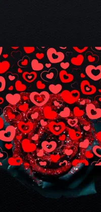 Decorate your phone with a stunning live wallpaper! This digital art features a beautiful image of someone holding a group of red hearts on a black background