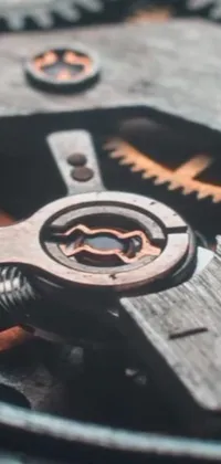 This phone live wallpaper features a close up of a watch face with moving gears