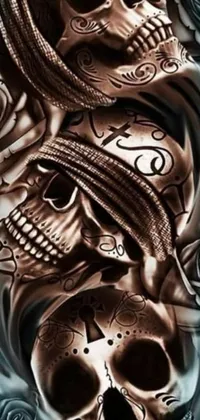 This phone live wallpaper features two intricately designed skulls in metallic black and brown colors