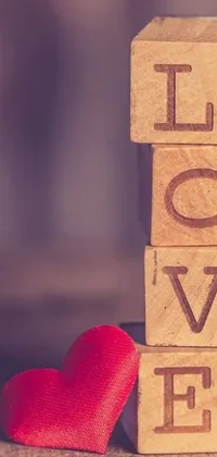 This live wallpaper features a charming and warm design with wooden blocks and a red heart