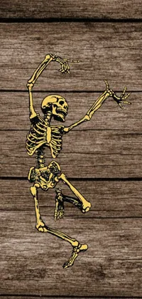 This phone live wallpaper showcases an animated woodcut of a jumping skeleton in warm gold tones