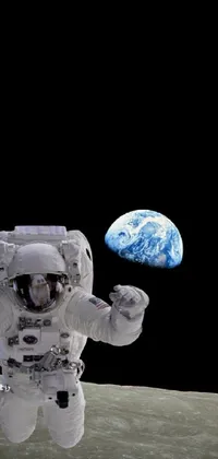 This spectacular live wallpaper features an awe-inspiring image of an astronaut exploring the moon, with the planet Earth visible in the background