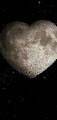 This live smartphone wallpaper showcases a heart-shaped object in the moonlit sky