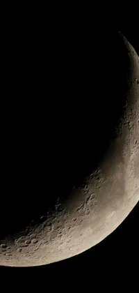 This live wallpaper captures the breathtaking beauty of a half moon against a dark, starry sky
