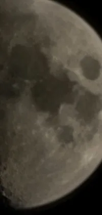 This phone live wallpaper showcases a black and white photo of the moon captured using an impressive 200mm focus