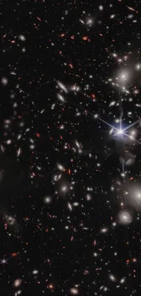 This smartphone live wallpaper reveals a captivating dark sky full of sparkling stars, dau-al-set, gravitational lens, remote glowing figures, partially spacey crystallized, silver and blue nebulas, and occasional shooting stars flying across the screen
