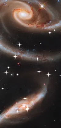 This captivating phone live wallpaper is inspired by our fascination with deep space and features two spiral galaxy-like objects in the sky