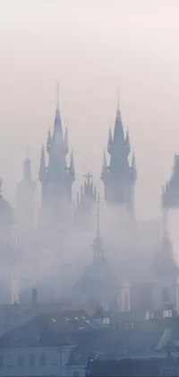 This phone live wallpaper features a breathtaking view of a baroque city engulfed in fog