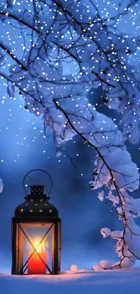This phone live wallpaper depicts a beautifully detailed lantern sitting in tranquil snow