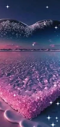 This phone live wallpaper features a heart-shaped ice block on a beach in a romantic pink landscape