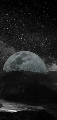 Looking for a stunning phone live wallpaper that will take your breath away? Check out this gorgeous black and white image of a full moon, set against a backdrop of distant mountains, stars, and the Milky Way