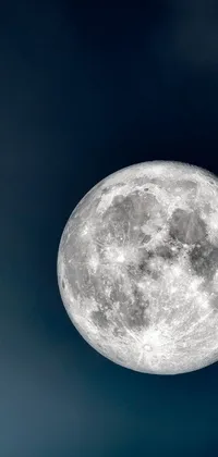 This stunning phone live wallpaper showcases a silver and gray metallic plane flying towards a circular white full moon, seen from below