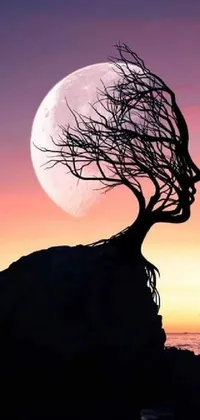 Immerse yourself in a surrealistic world with this live wallpaper featuring a majestic tree, rocky formation, and ocean