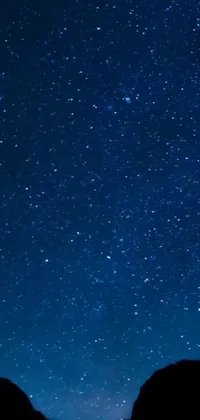 Looking for a stunning live wallpaper for your phone? Look no further than this mesmerizing night sky- blue background adorned with countless stars that twinkle and glitter, creating an enchanting, peaceful atmosphere