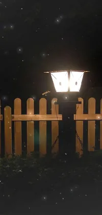 This phone live wallpaper features a street light and wooden fence set against a summer night backdrop