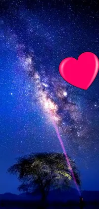 Experience a stunning live wallpaper where a tree with a heart stands in front of a person daydreaming about kissing a girl under the beautiful milky way sky