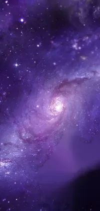This vibrant phone live wallpaper showcases a spiral galaxy in all its glory, set against a backdrop of twinkling stars and purplish hues