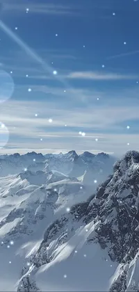 This phone live wallpaper features a snow-covered mountain range with clear blue skies, capturing the serene atmosphere of nature