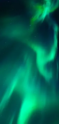 This stunning live wallpaper showcases the aurora borealis, lighting up the sky with vibrant shades of green and purple