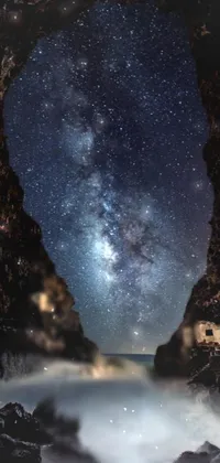 This live phone wallpaper showcases a stunning night sky view from within a cave