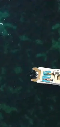 This phone live wallpaper showcases a mesmerizing scene in which a boat glides smoothly on water