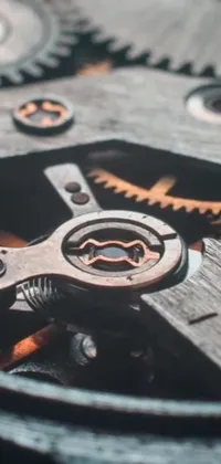This phone live wallpaper showcases detailed watch gears set against a wooden background with a weathered appearance