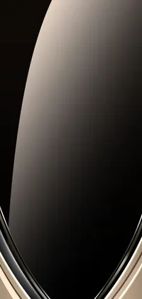 This elegant phone live wallpaper depicts a black and gold shield set against a black background