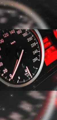 This live phone wallpaper showcases a red-tinted screenshot of a car's speedometer by Kurt Roesch