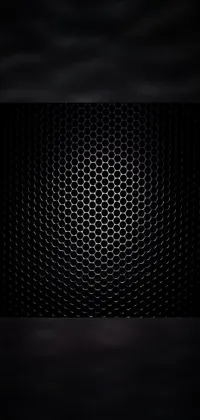 This phone live wallpaper features a detailed silver metallic grill pattern covering a huge black circle on a sleek black color background
