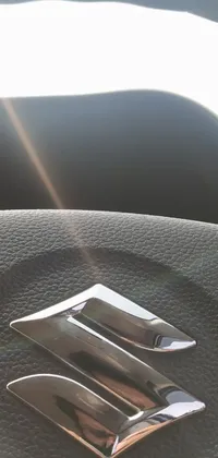 This phone live wallpaper captures a close-up of a steering wheel on a futuristic Suzuki car