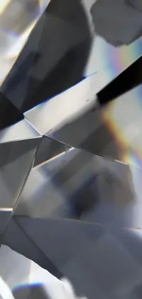 This phone live wallpaper showcases a stunningly realistic, shiny diamond with intricate cuts and angles