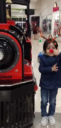 This lively phone live wallpaper features an adorable little girl standing next to a colorful toy train, all depicted in the vibrant toyism style