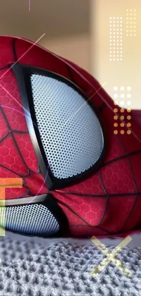 This live phone wallpaper showcases a highly detailed, photorealistic close-up shot of a stuffed Spider-Man figure lying on a bed