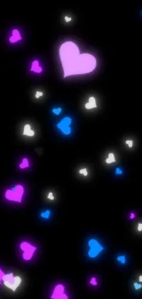 This phone live wallpaper features Tumblr-style blue and pink hearts set against a black background