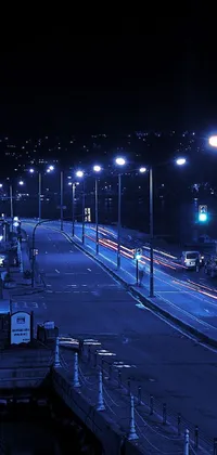 This phone live wallpaper depicts a bustling city street teeming with traffic at night
